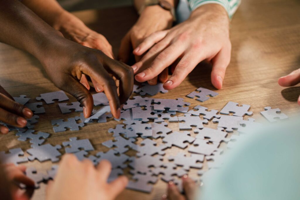 People doing a jigsaw puzzle.