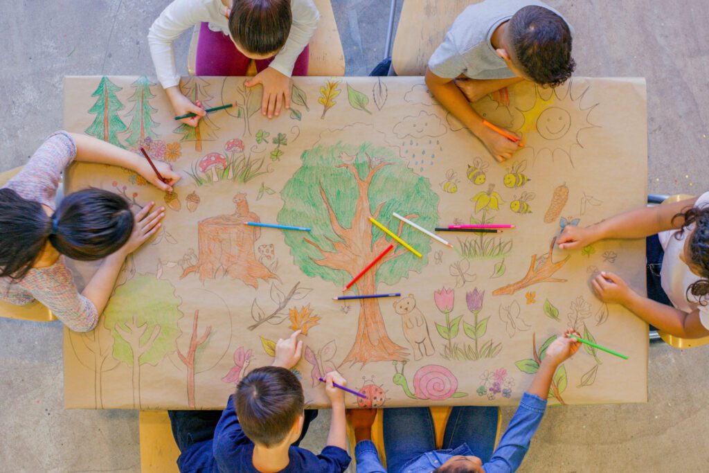 Children drawing on a table.