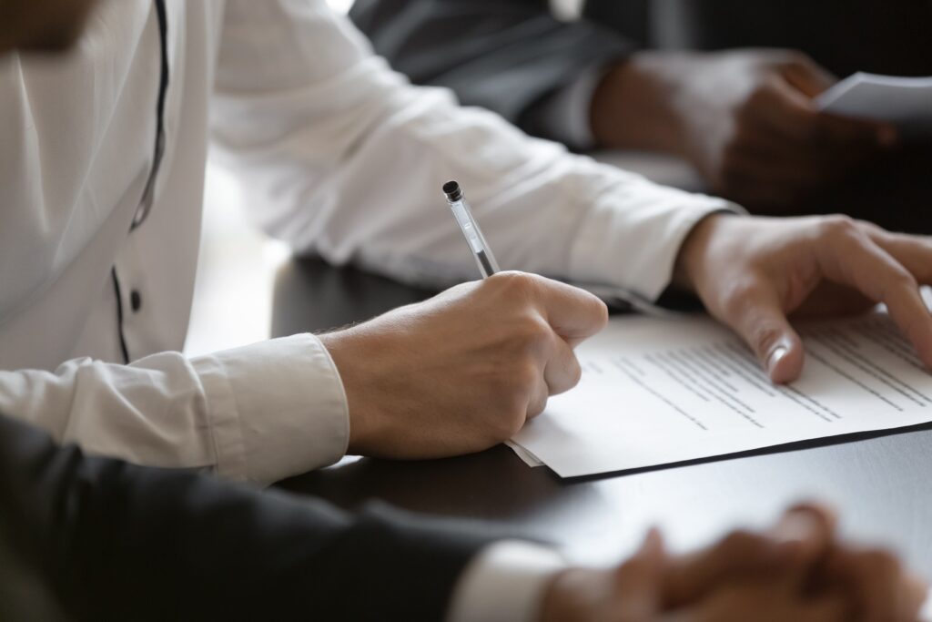 A man signing a document.