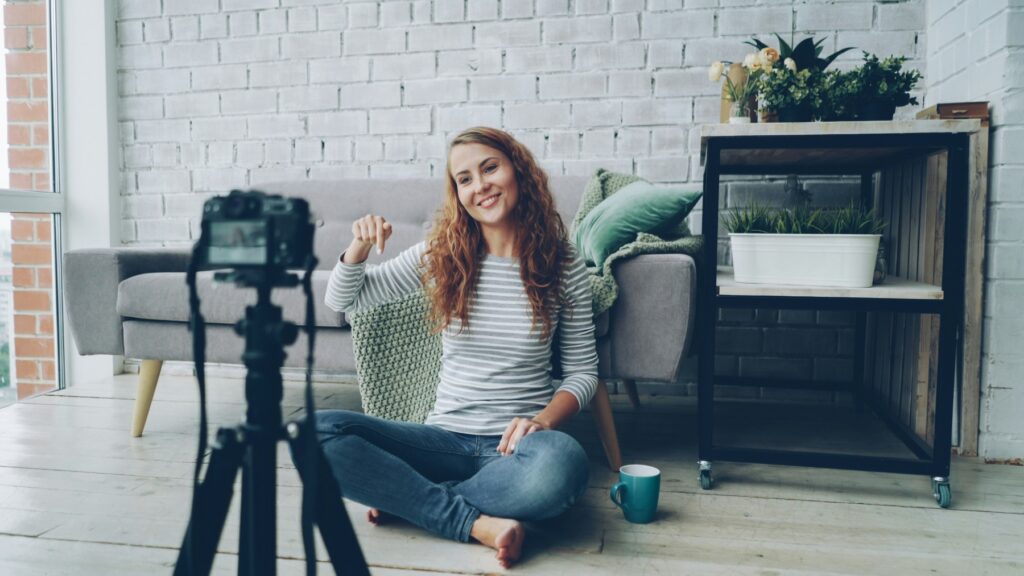 A woman smiling in front of a camera